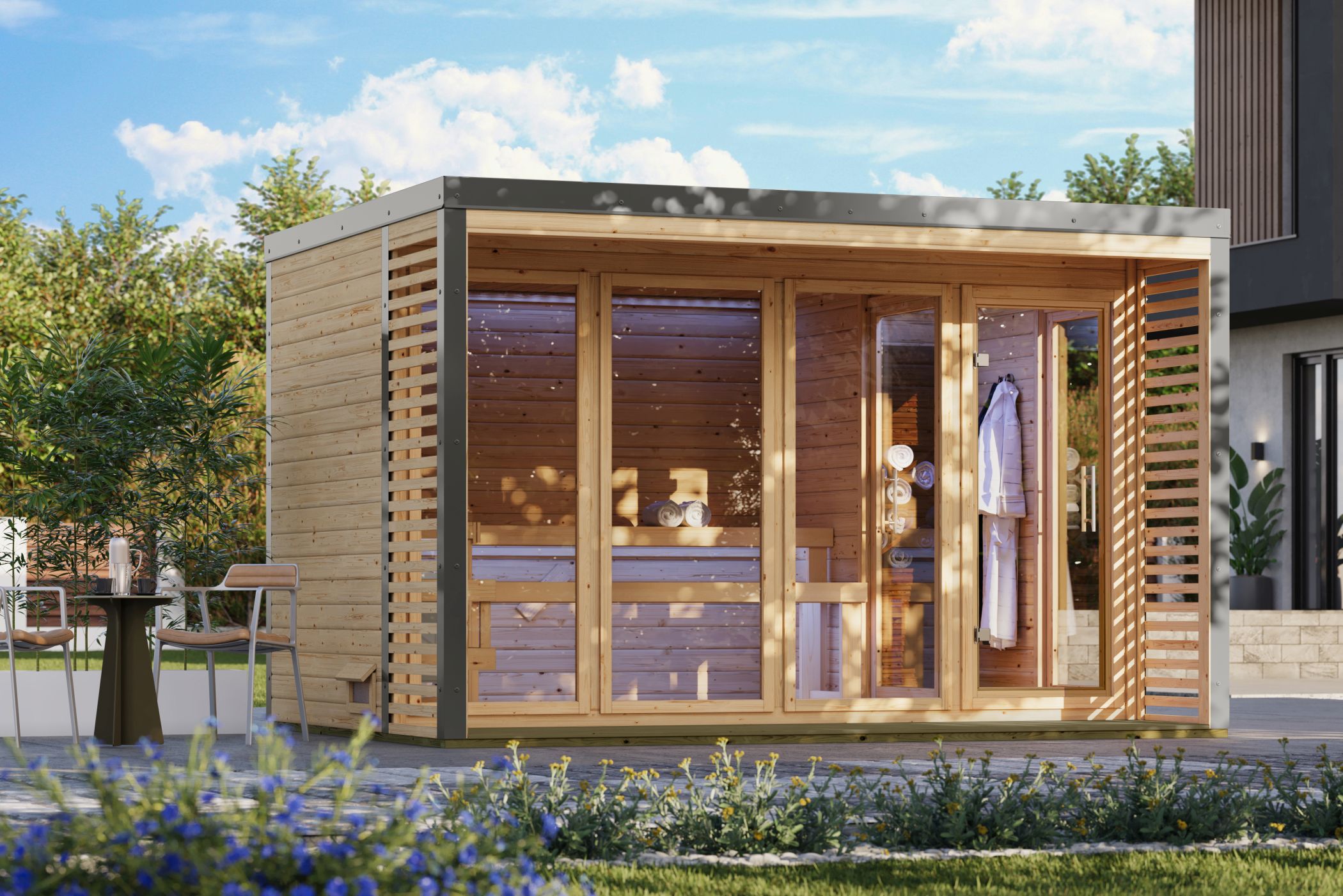 Karibu Saunahaus Ares 4 als Gartensauna aus Massivholz im Garten mit Glasfront