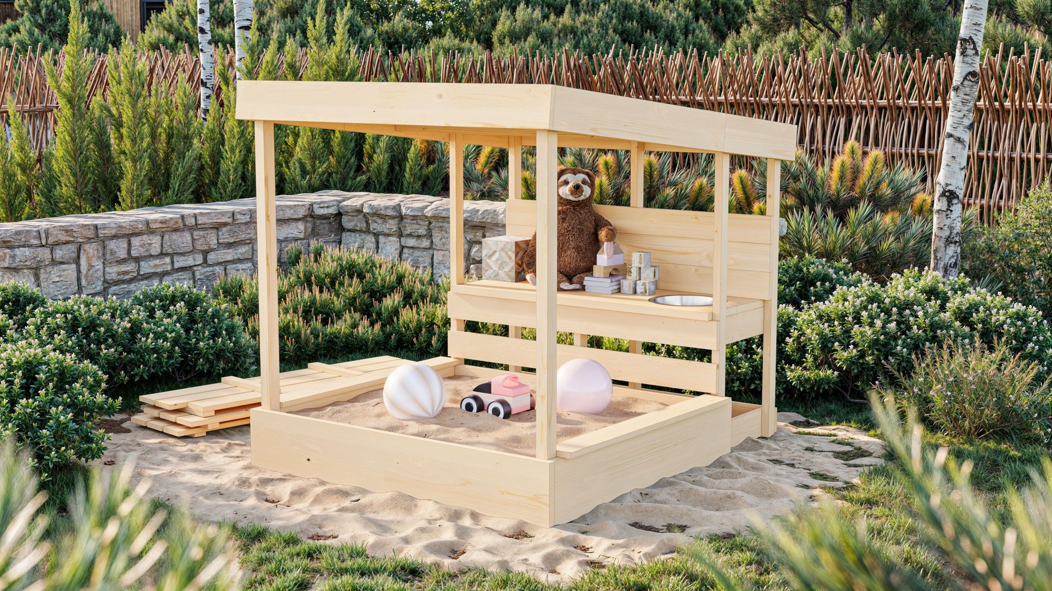 Karibu Sandkasten Max mit Dach und Matschküche aus Holz, im Garten aufgebaut