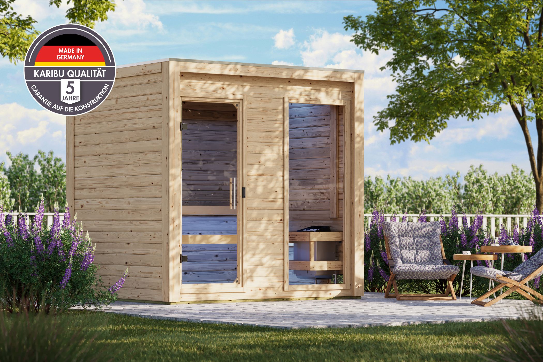 Karibu Saunahaus Hycore 2 als Gartensauna aus Massivholz im Garten mit Glasfront